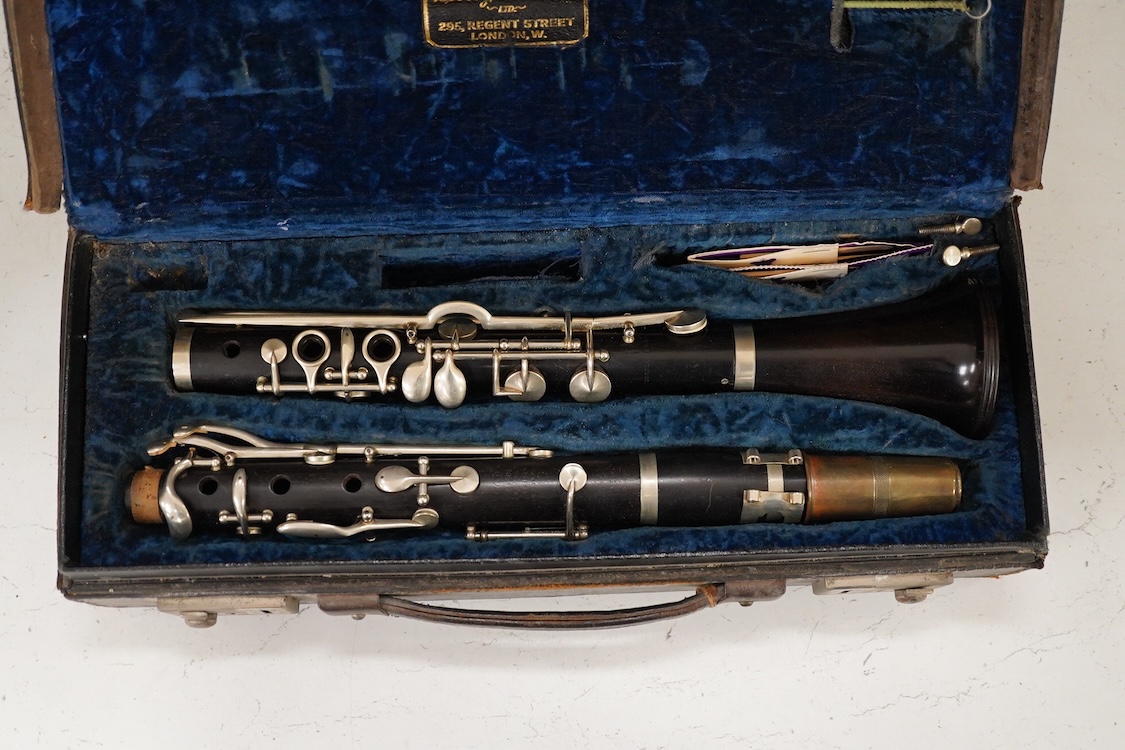 An early 20th century wooden Boosey and Hawkes clarinet in a fitted leather case